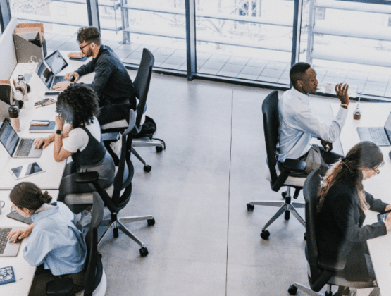 aerial view of an office with 5 people working at desks