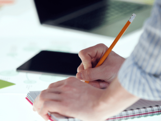 Close up of someone writing in a notebook