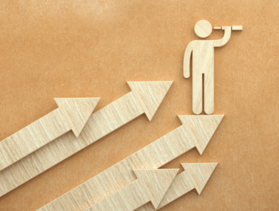 A person looking through a telescope on a set of upwards pointing arrows