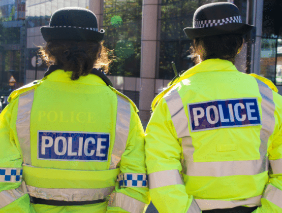 Two police officers walking in uniform together