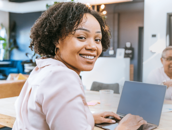 Female office worker working on a laptop