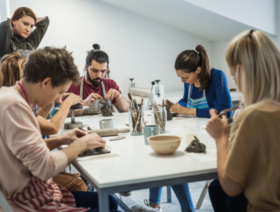 A group of people sitting around a table doing a creative task