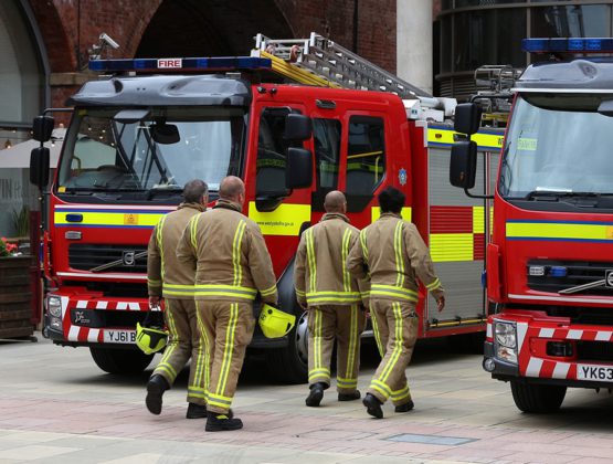 Group of firefighters walking towards fire engines