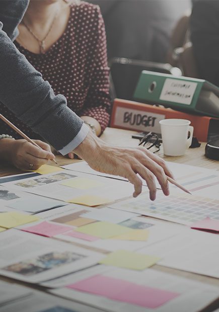 Two office workers looking over some documents together