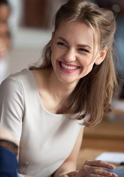 Woman smiling at colleagues
