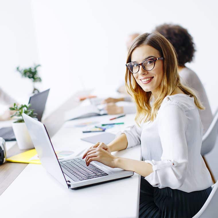 Office worker smiling at the camera in a meeting