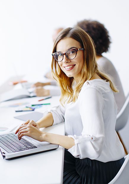 Office worker smiling at the camera in a meeting