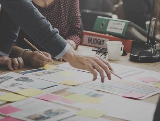 Two colleagues working together with paper documents