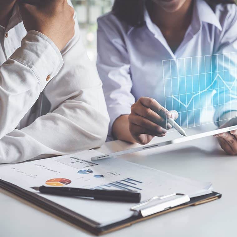 Two office workers looking at some paperwork