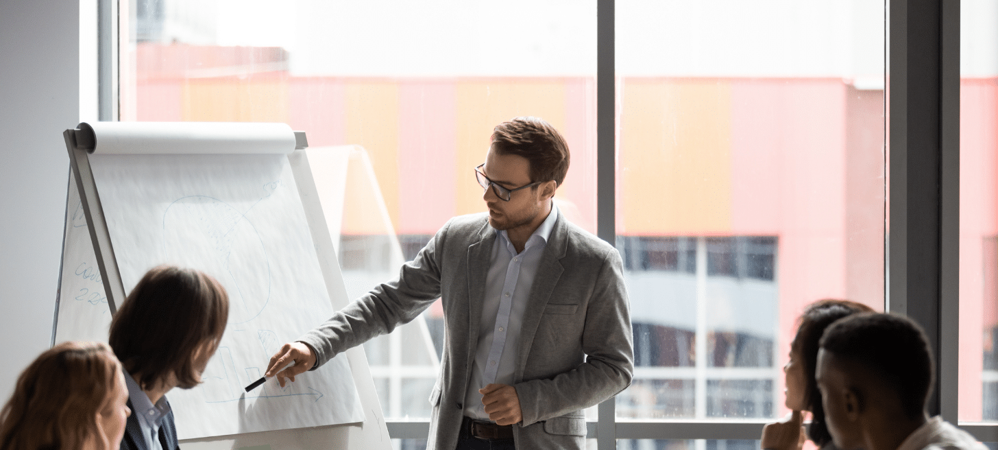 Person giving a presentation to colleagues in an office environment.