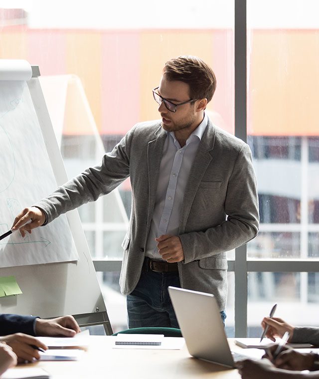 Male office worker leading a group of colleagues in a meeting