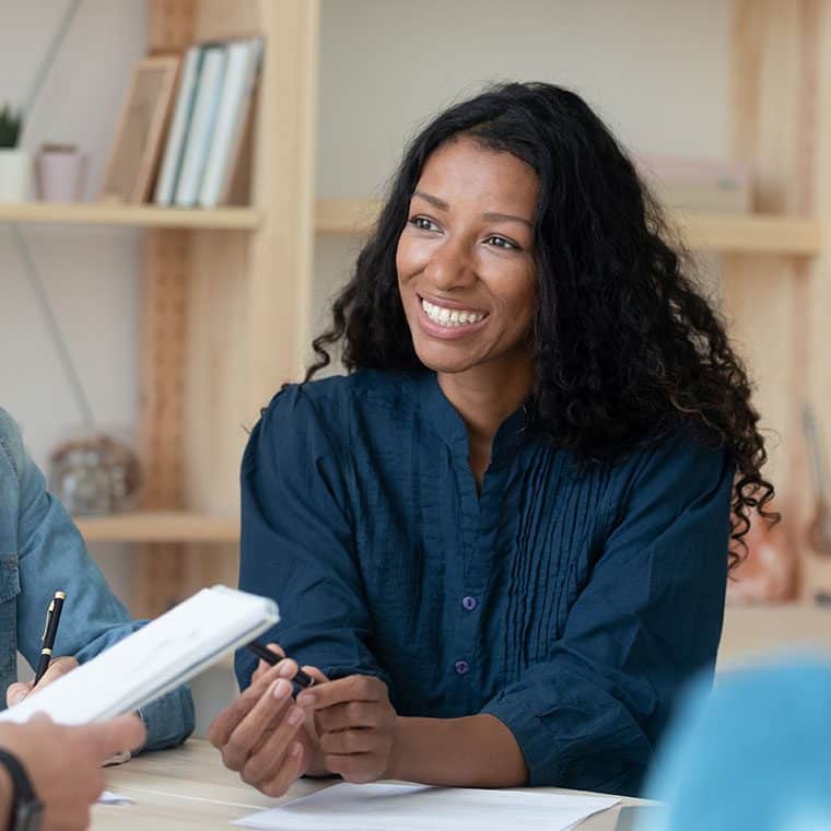 Woman smiling in a meeting in an office environment