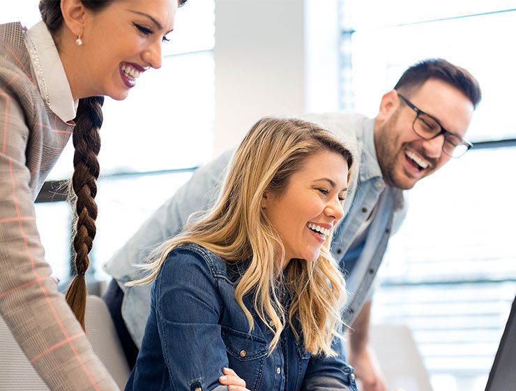 3 colleagues looking at a screen together