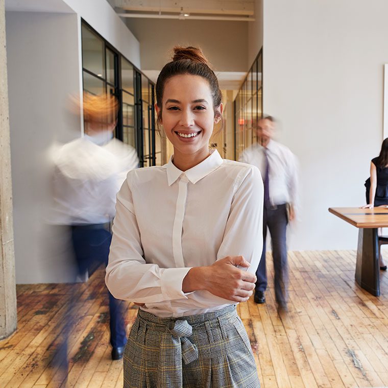 Woman in busy office building