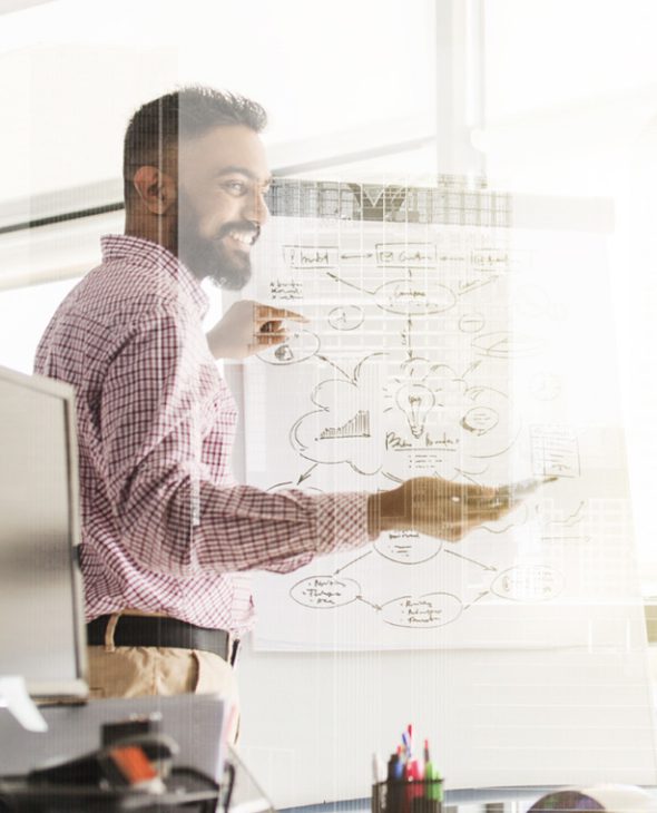Man leading a team meeting in an office