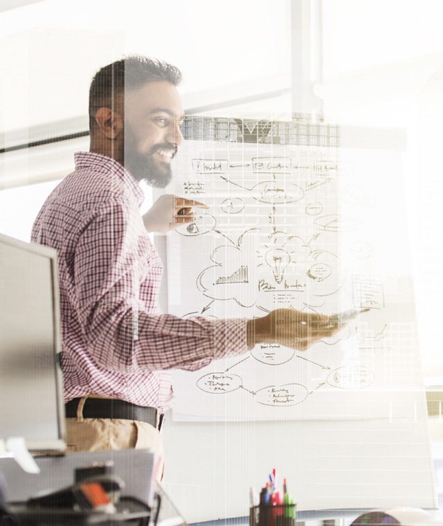 Man leading a team meeting in an office