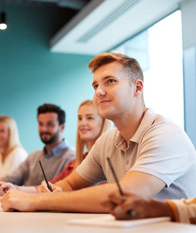 Group of apprentices listening in a classroom