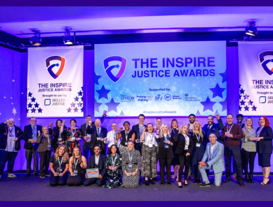 Inspire Justice Award winners with their trophies on stage