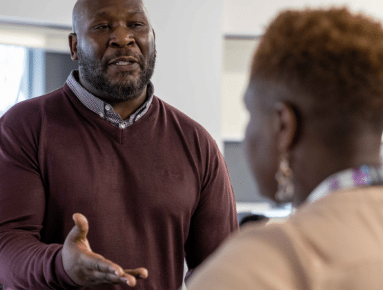 Two people having a conversation in a justice sector setting