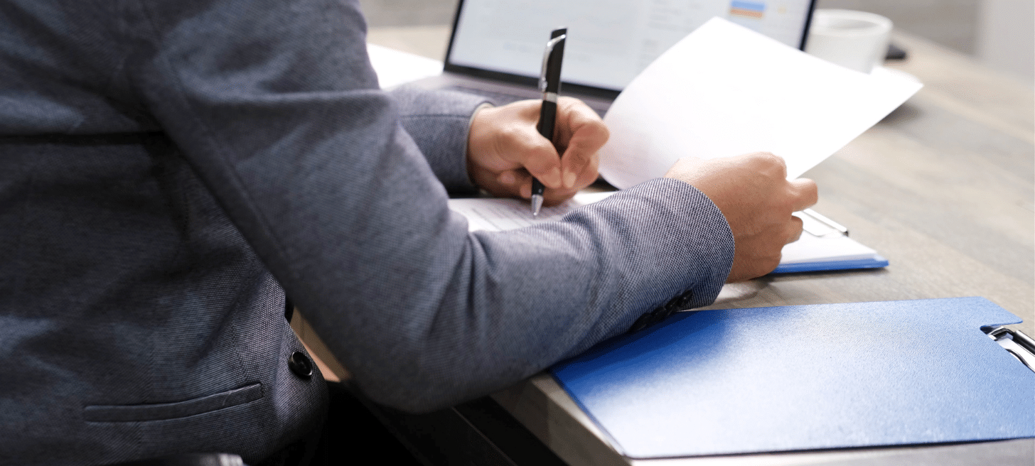 Person looking through documents at a desk