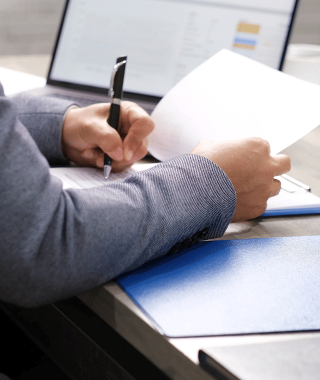 Person looking through documents at a desk
