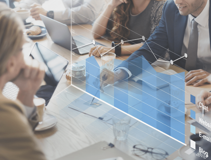 A group of colleagues in a meeting, a graph is overlayed.