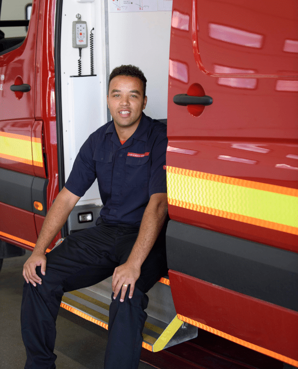 Firefighter sitting in vehicle at fire station