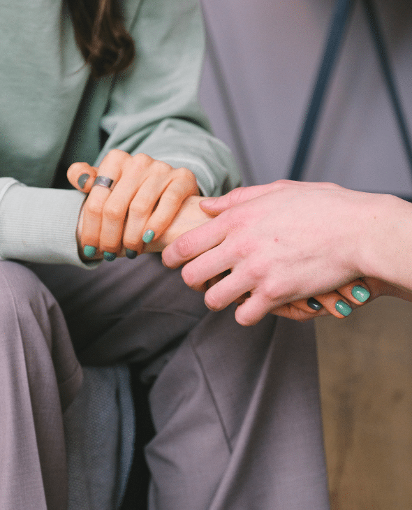 Woman's hands are held supportively