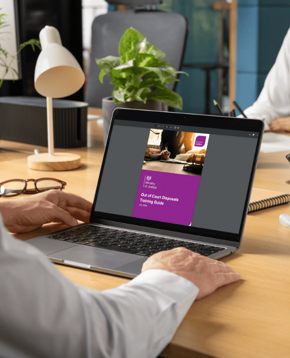 Out of Court Disposals Training Guide on a laptop screen