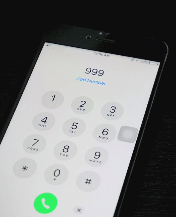 Close up of iPhone dialling 999