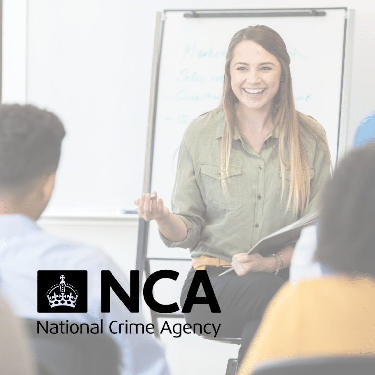 Woman leading a training session. She holds a clipboard and is sat in front of a flipchart. National Crime Agency (NCA) logo is overlayed.