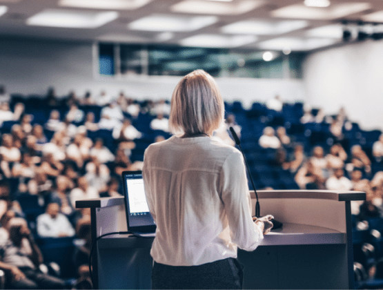 Speaker giving a talk at conference.