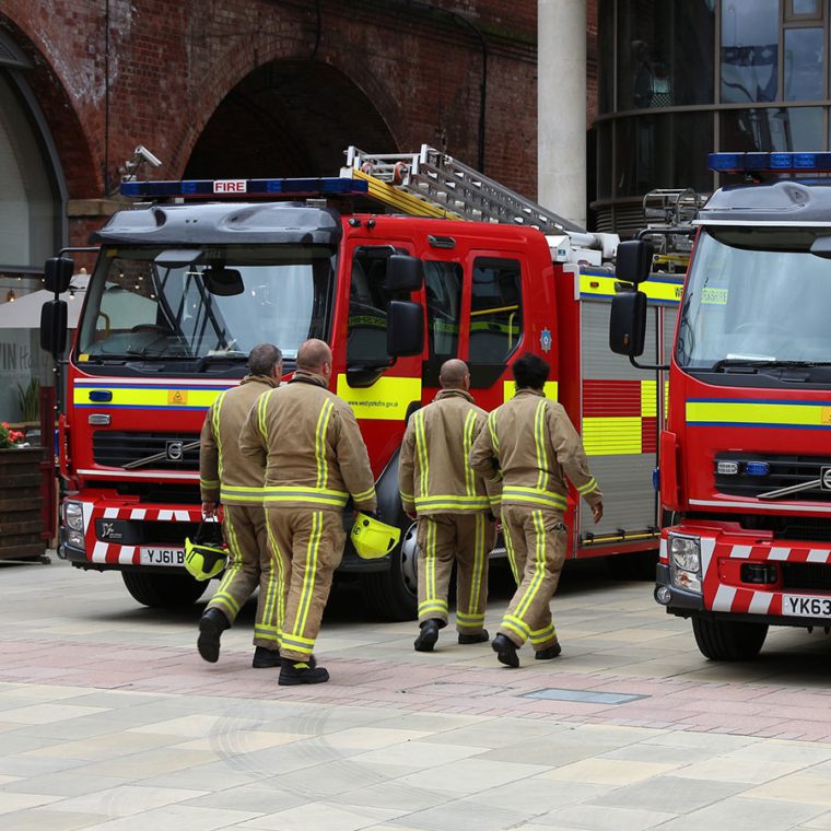 Group of firefighters walking towards fire engines
