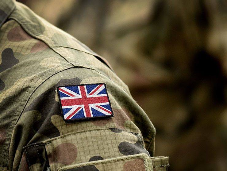 Shoulder of British soldier with Union Jack on uniform.