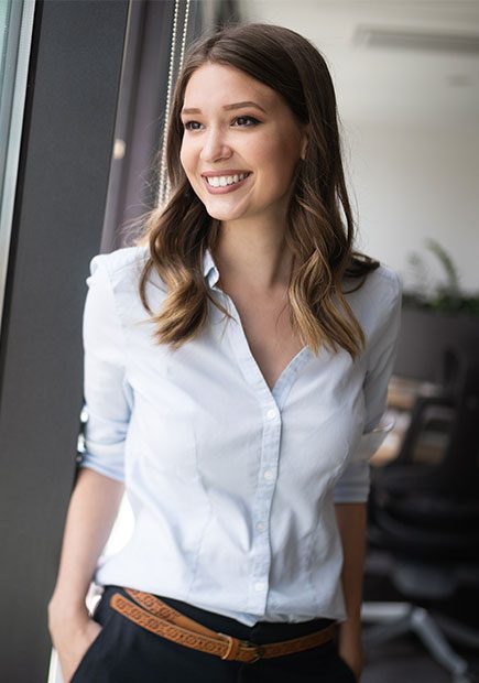 Woman in office smiling out of the window
