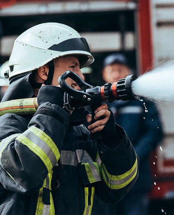 Firefighter using hose