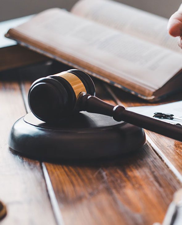 Gavel on table with paperwork.