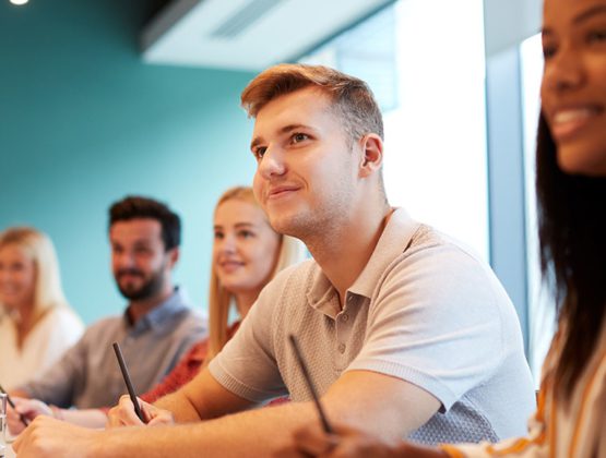 Group of apprentices listening in a classroom